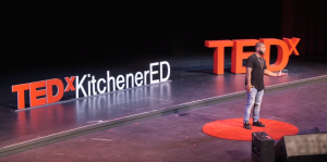 man on a TEDx stage